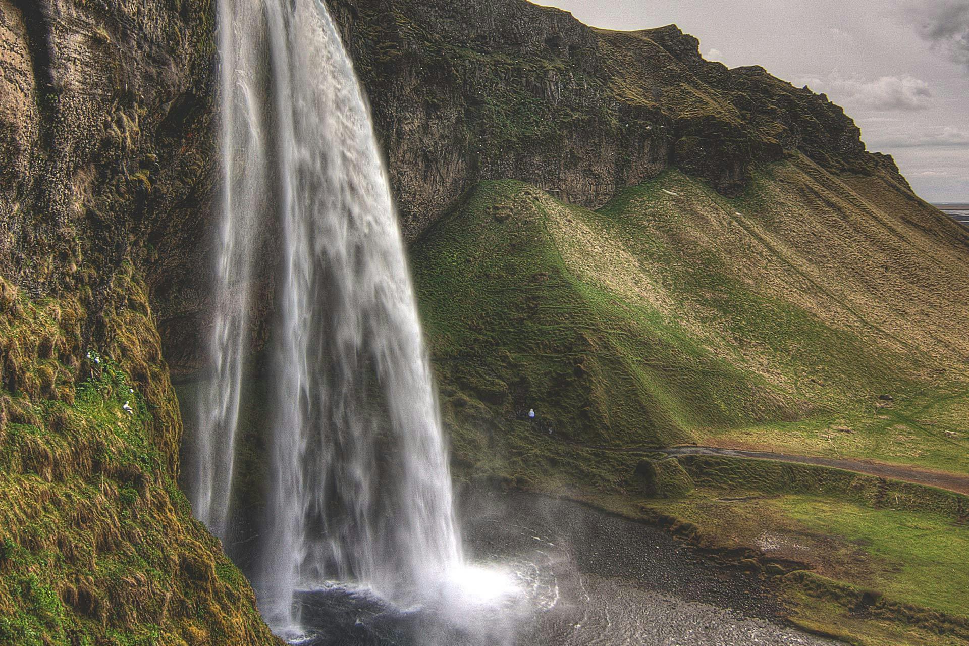Witness Seljalandsfoss waterfall cascade down cliffs of the South Coast on a 4-day tour of southern Iceland.