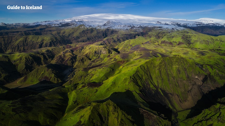 コケで覆われたアイスランドの山の向こうには氷河が見える