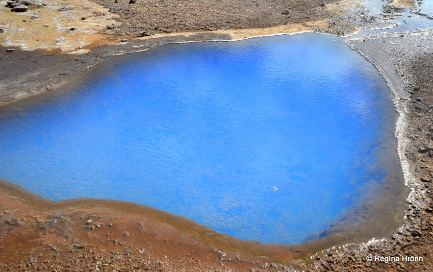 Blue pool of hot geothermal water in Geysir geothermal area in southwest Iceland.