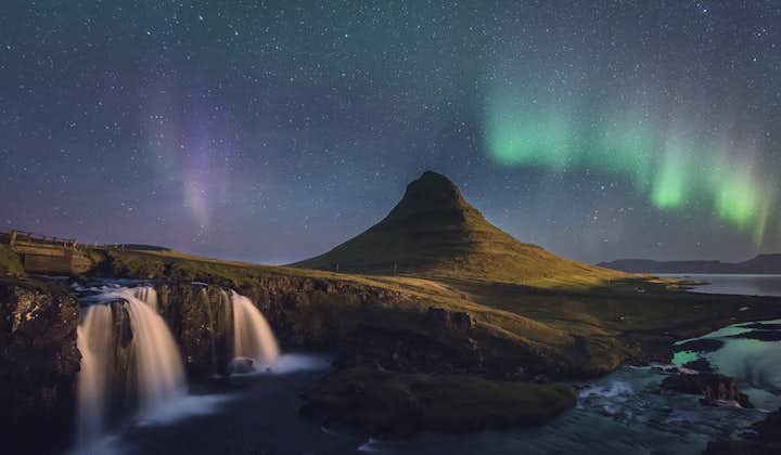 Explore the arrowhead-shaped mountain, Kirkjufell, as the Northern Lights dance above with a winter self-drive tour.