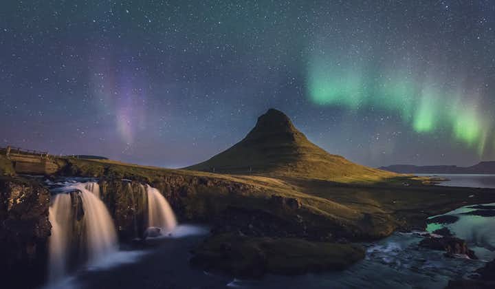 Explore the arrowhead-shaped mountain, Kirkjufell, as the northern lights dance above with a winter self-drive tour.