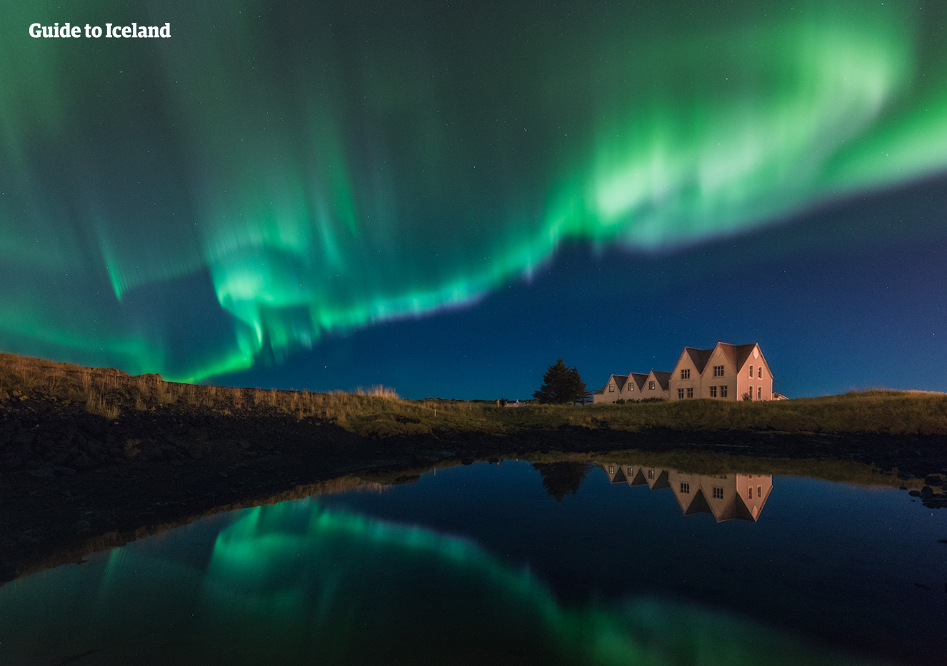 The beautiful Northern Lights dancing over a lonely house on the Reykjanes Peninsula.
