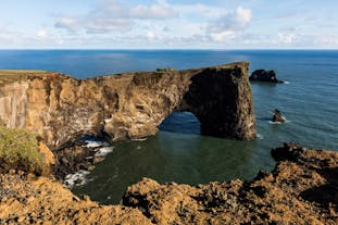 A sea arch and the Atlantic Ocean on the Dyrholaey Peninsula in South Iceland.