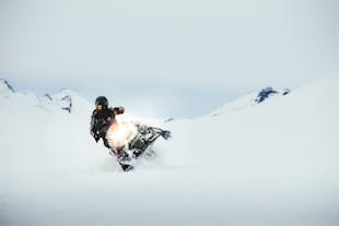 A person maneuvering their snowmobile at Langjokull glacier.