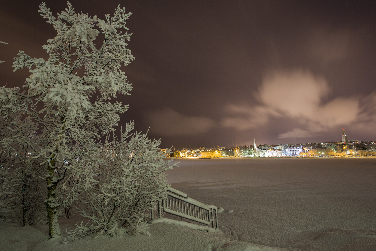 Cosy glow of the city lights in snow-covered Reykjavík.