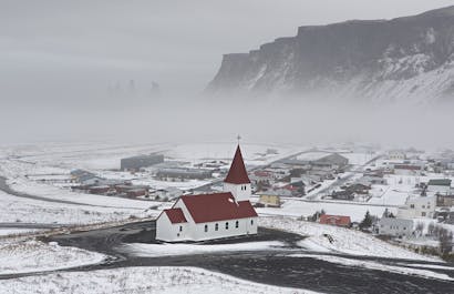 The charming town of Vík on the South Coast powdered in winter snow.