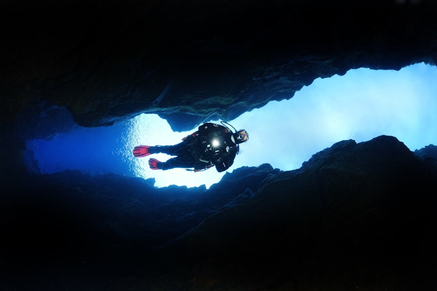 A scuba diver descends into the depths of Silfra Fissure.