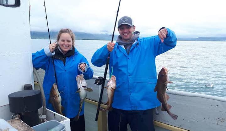 Proud anglers displaying their impressive catches during an exciting day on the sea fishing tour.
