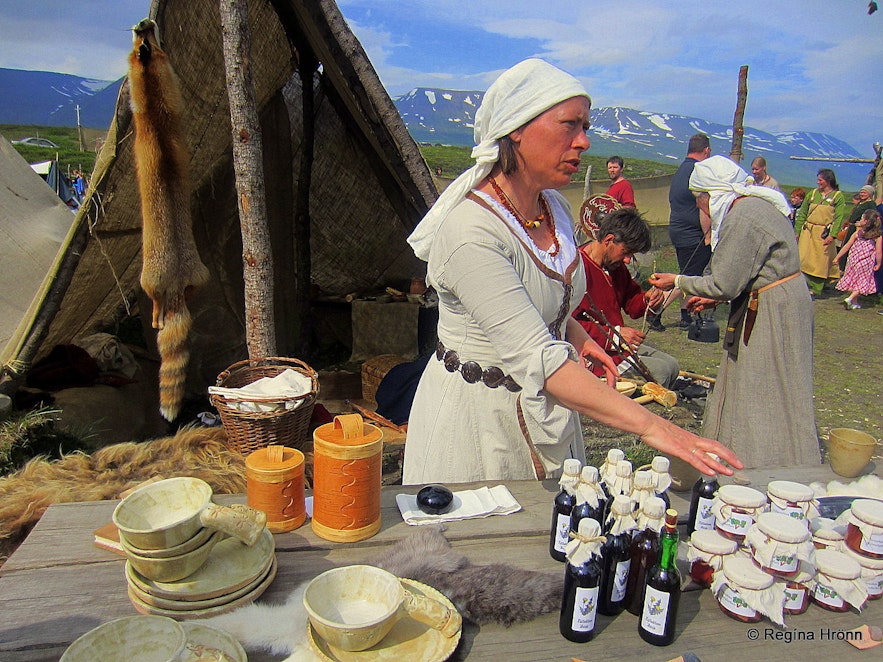 Woman selling goods at the medieval market at Gásir