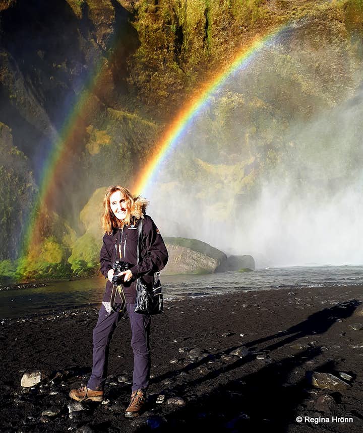 Regína and a rainbow at Skógafoss Waterfall in South-Iceland