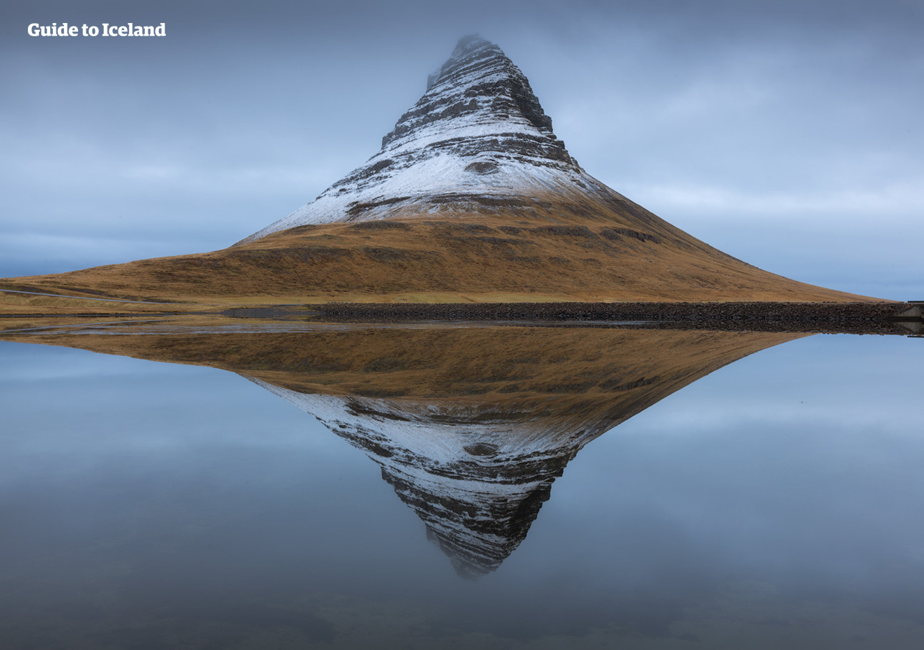 On a still winter day in Iceland, Mount Kirkjufell reflects beautifully in the sea.