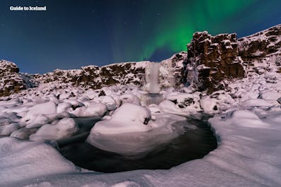 Öxarárfoss is a waterfall in south-west Iceland, pictured under the northern lights in winter.