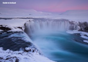 The stunning Goðafoss waterfall blanketed with snow.