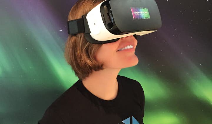 A woman enjoying a virtual reality tour at the Aurora Reykjavík exhibition.