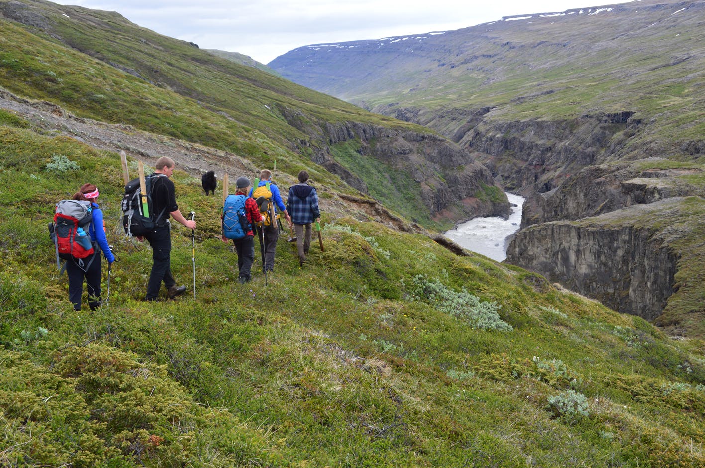 Hikers passing a river gorge in east Iceland.