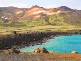A beautiful blue cove with mountainous terrain behind it, Iceland