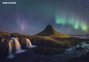 The fabulous Northern Lights dance across the sky behind one of the most photographed mountains, Mount Kirkjufell on the Snæfellsnes Peninsula.