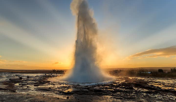 The stunning geyser Strokkur erupts amid the winter landscape.