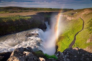 A rainbow forms above the cascade of the Gullfoss waterfall in Iceland.