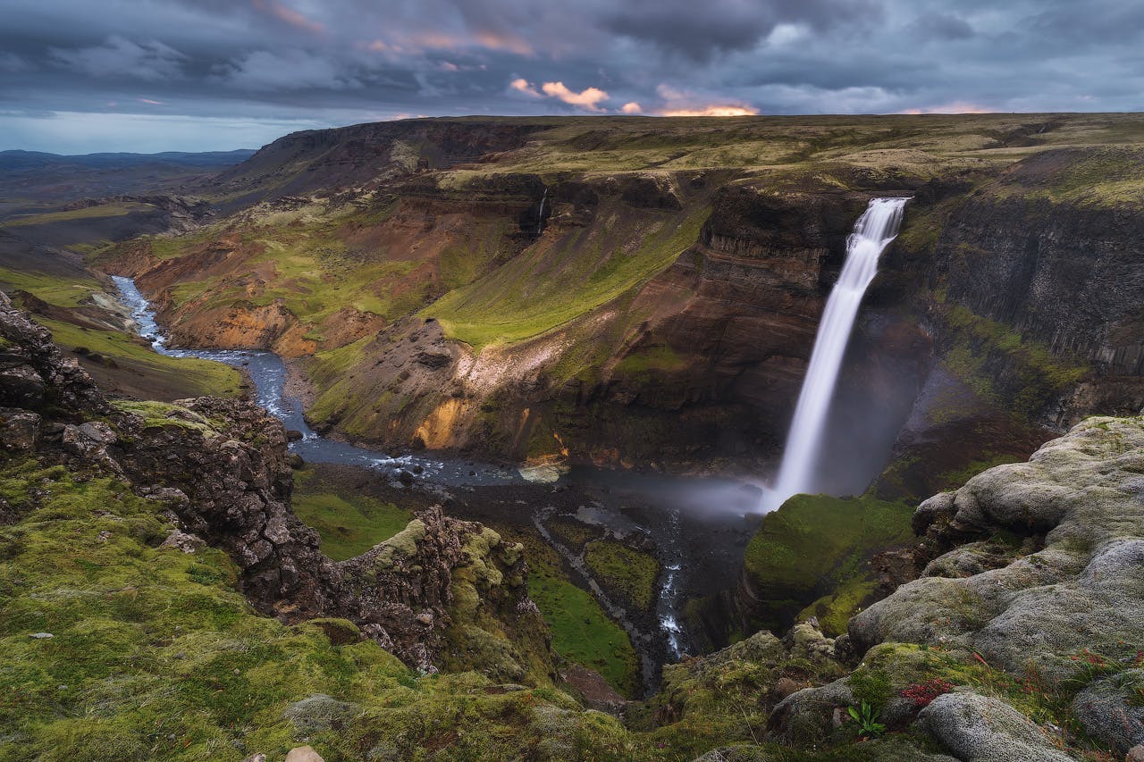 一名专业的摄影师正在冰岛高地拍摄迷人的瀑布和山谷