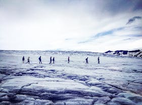 A group of people hike across Vatnajokull glacier.