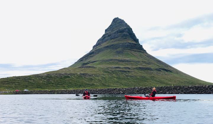 Kirkjufell Mountain is seen in the background as kayakers happily enjoy the tour