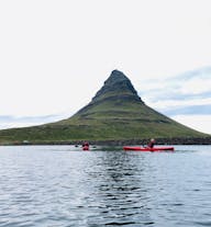 Kirkjufell Mountain is seen in the background as kayakers happily enjoy the tour