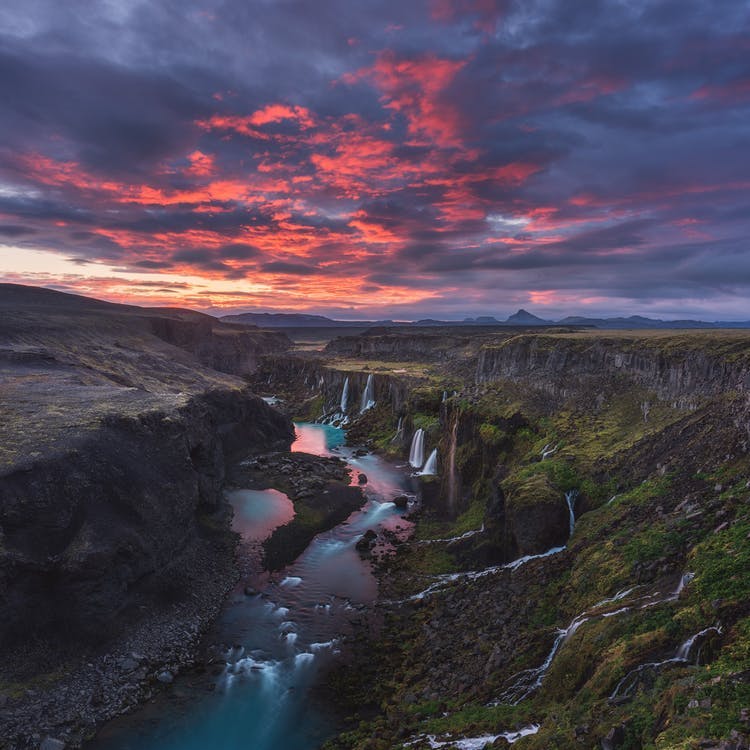 Iceland's highlands are decorated with patches of snow and river system.