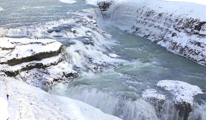 Embark on a snowy journey to witness Gullfoss adorned in winter's icy splendor, a breathtaking scene on the Golden Circle expedition.