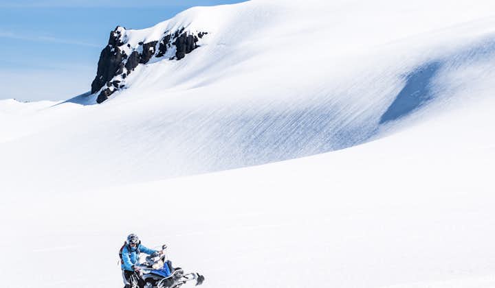 Person exploring Vatnajokull glacier on a snowmobile.