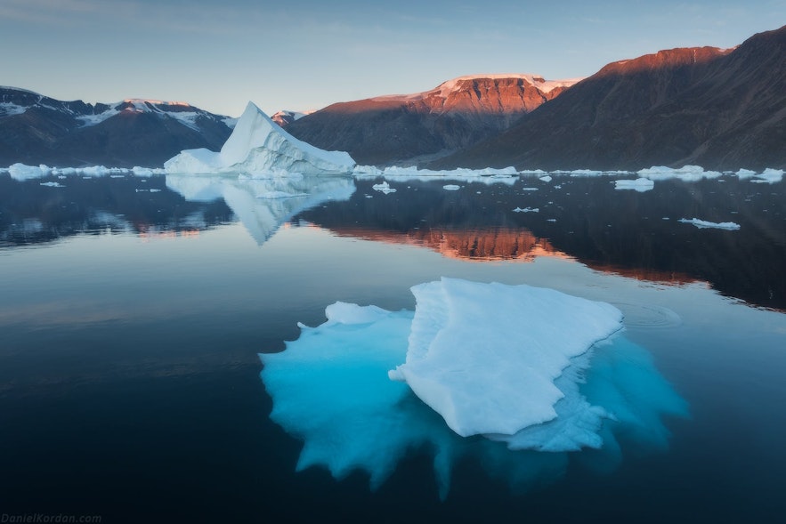 East Greenland is a land of enormous table-top mountains, plunging fjords, and giant icebergs in summer.
