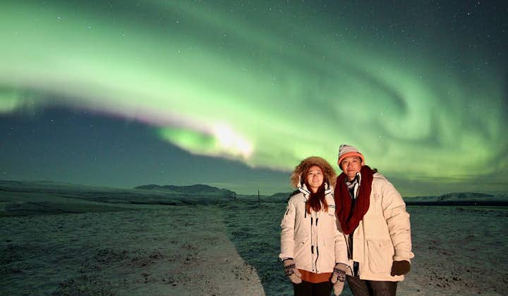 A happy couple enjoying the northern lights