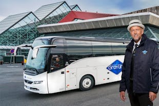 Our professional driver poses with one of our buses behind him.
