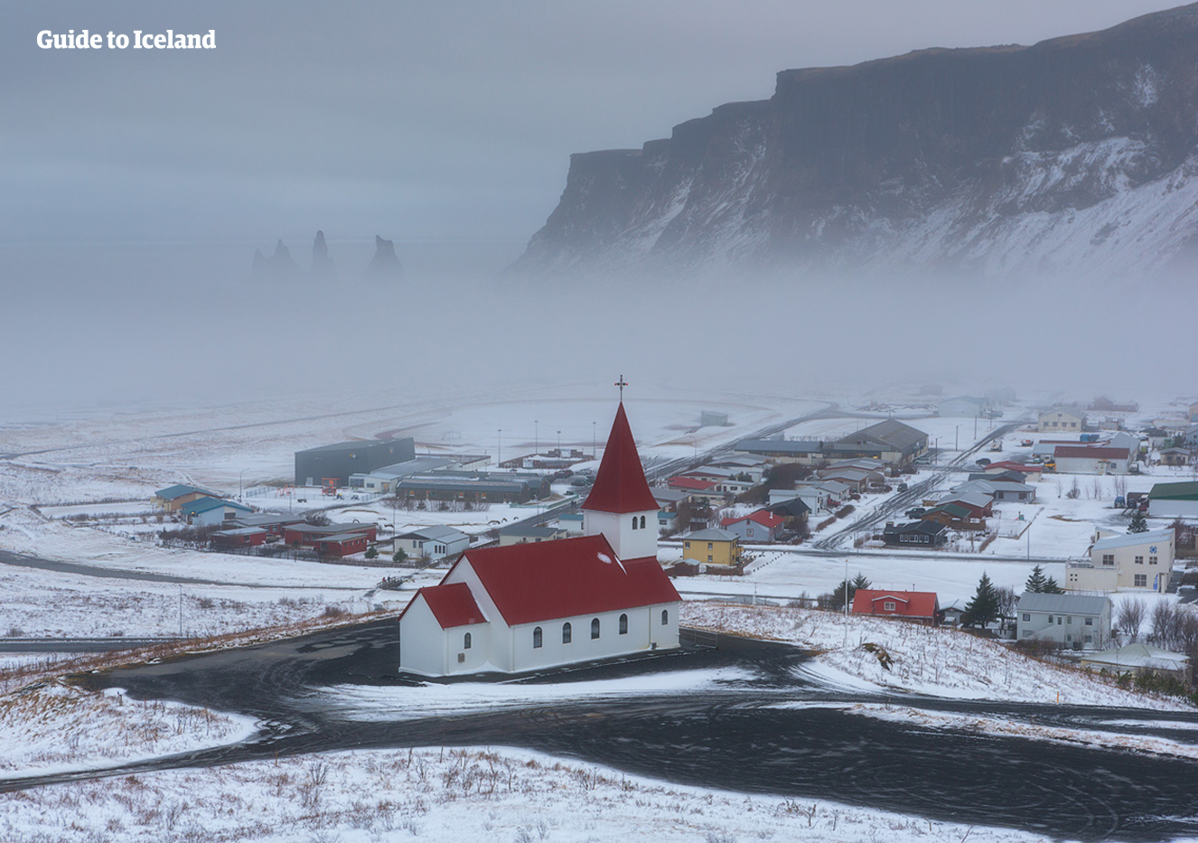 A fresh layer of snow powders the picturesque village on Vík on the South Coast of Iceland.
