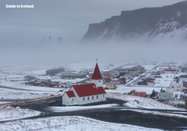 Świeża warstwa śniegu pokrywa malowniczą wioskę na Vik na południowym wybrzeżu Islandii.