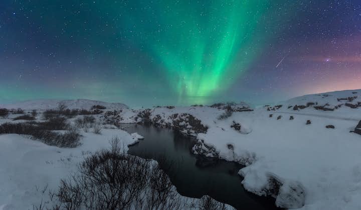 Þingvellir National Park, here under the winter Northern Lights, is the best place to snorkel in Iceland.
