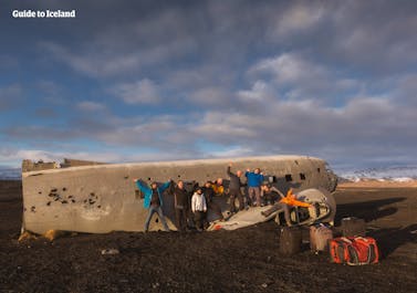 People looking at the wreck of the DC plane which crashed in South Iceland in 1973.