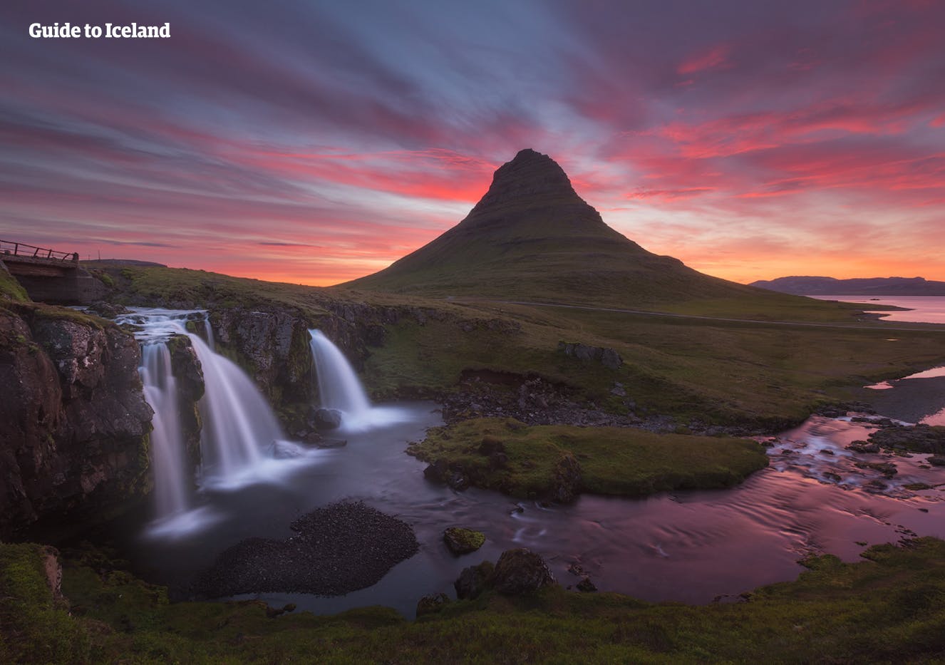 The triple cascade of Kirkjufellsfoss constitutes a beautiful foreground for Mt. Kirkjufell, as its peak is painted gold by the midnight sun of Iceland.