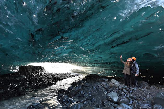 A stream creeps out of an Icelandic ice cave in winter.