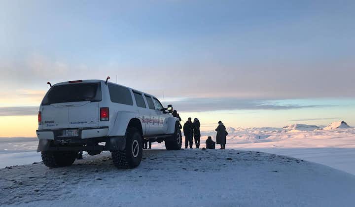 A group gets out of their monster truck during a private tour for magnificent vistas from the Langjokull glacier.