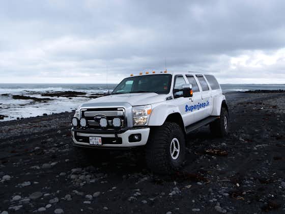 Explore the otherworldly beauty of black sand beaches in a rugged super jeep.