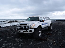 Explore the otherworldly beauty of black sand beaches in a rugged super jeep.