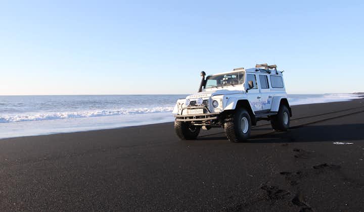 A super jeep on a black sand beach by the Atlantic Coast in South Iceland.
