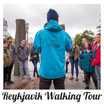 A guide speaks to a group of people on a walking tour of Reykjavik.