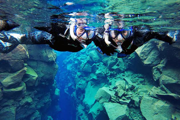 Two cheerful people on a Silfra fissure snorkeling tour