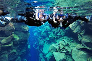 Two cheerful people on a Silfra fissure snorkeling tour