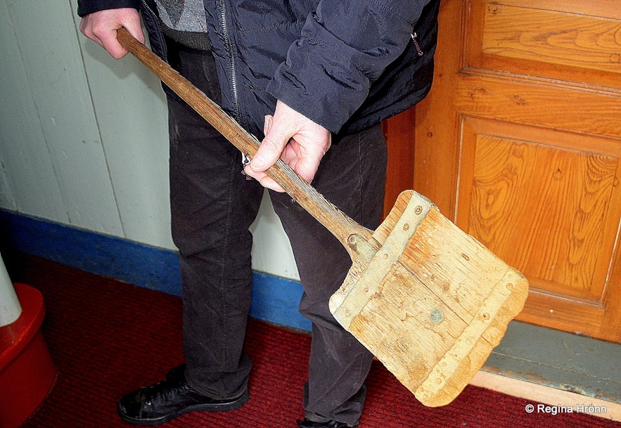The farmer at Prestbakki holding a shovel, which is a part of the burial tools of the church