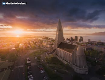 Hallgrimskirkja in Reykjavik with the setting sun creating a beautiful glow over the city.
