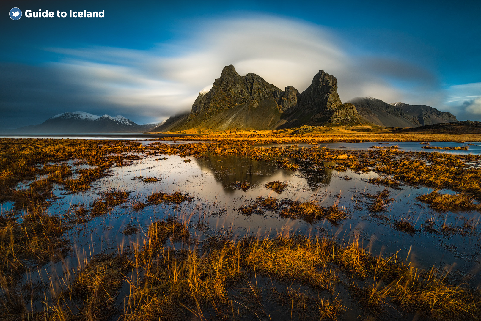 Eystrahorn Mountain in East Iceland overlooking a body of water in summer.