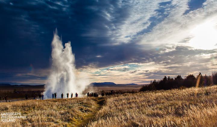 People watch the Strokkur geyser explode high in the air at the Geysir geothermal area on the Golden Circle route.